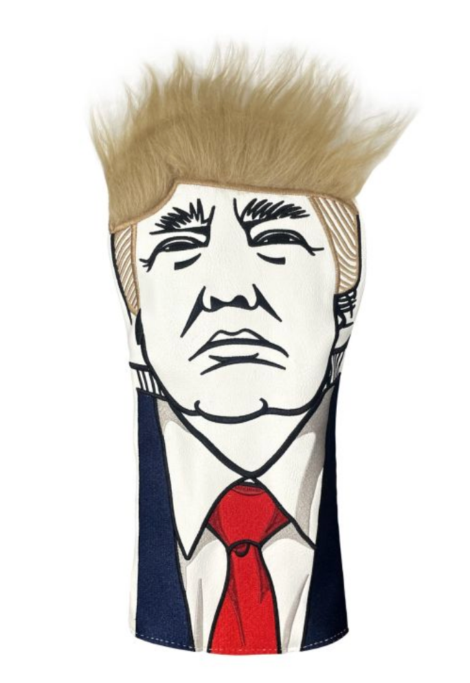 Golfkøllehodedeksel med en karikatur av en persons ansikt, med tydelig hår og en dress med rødt slips