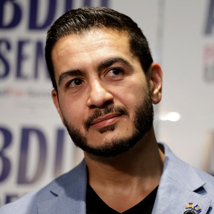 Mann i dress som står foran kampanjeskilt med «ABDUL for US SENATE» synlig i bakgrunnen