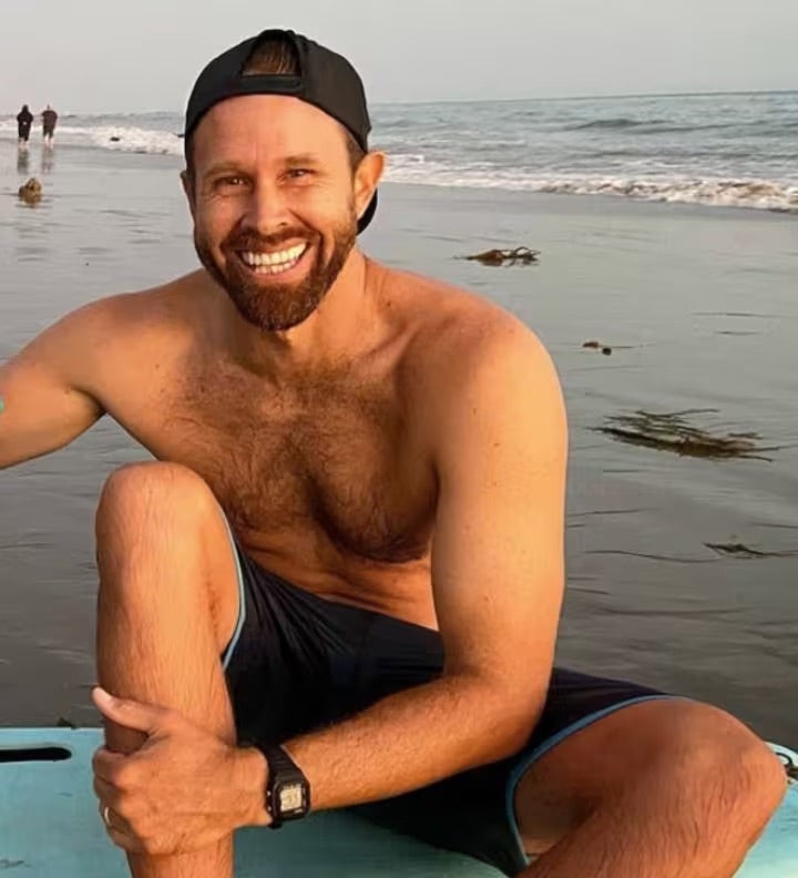Matthew Coleman smiler på en strand